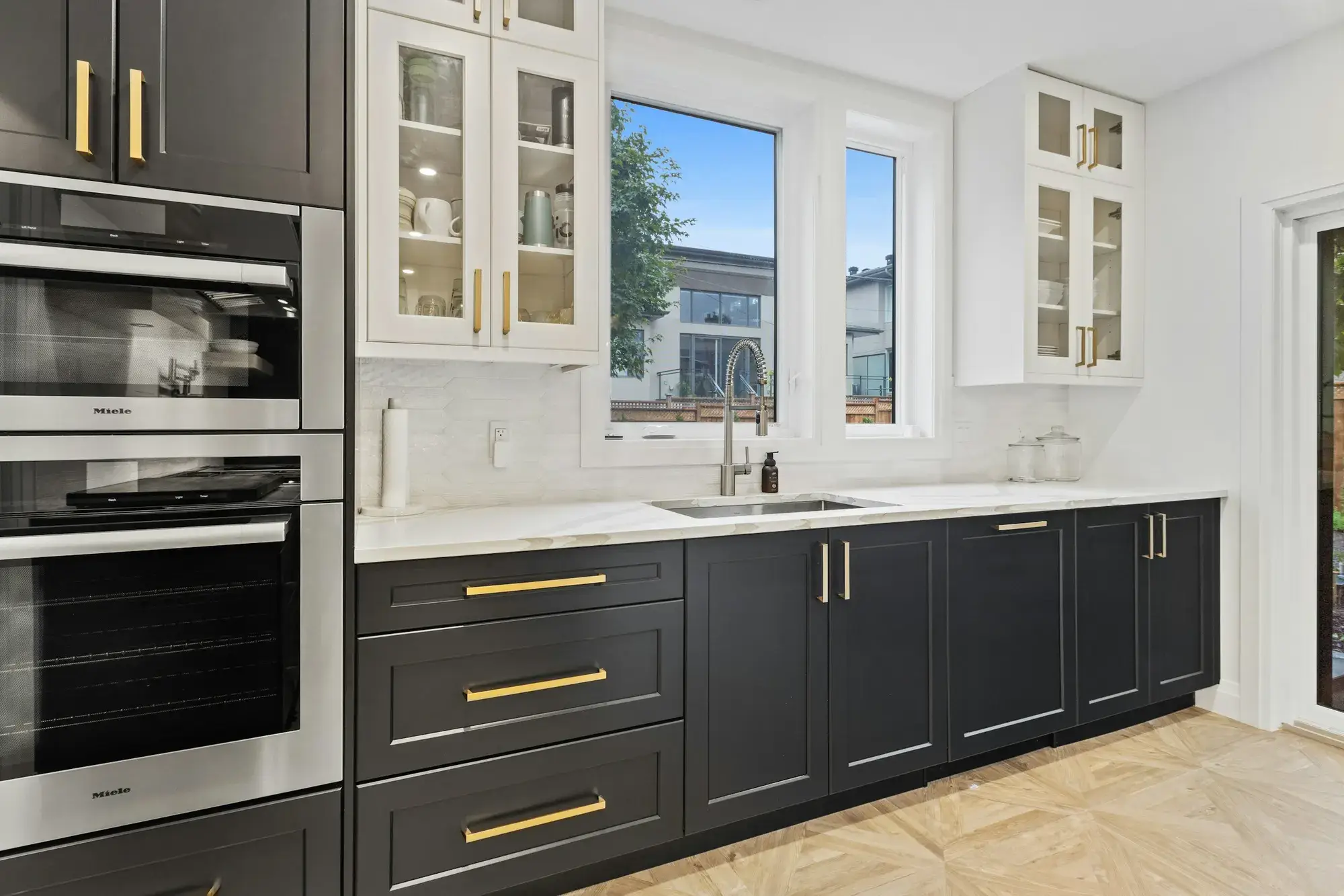Stainless built-in wall oven and microwave set flush in dark shaker cabinetry