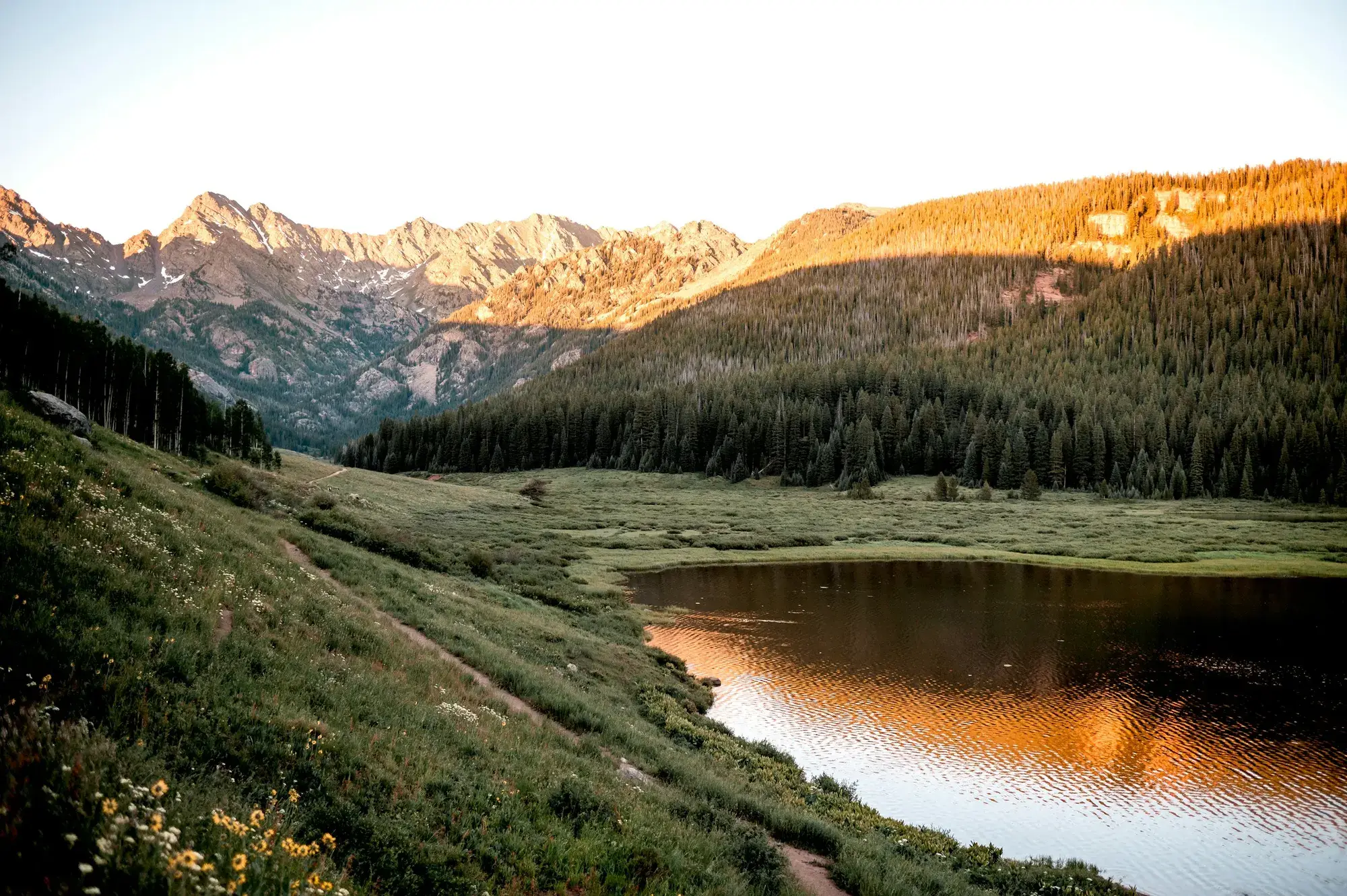 Alpenglow on the Gore Range above a lake near Vail